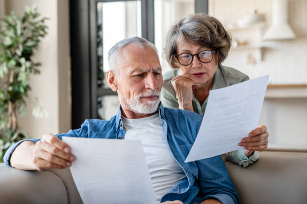 Old couple reading documents.